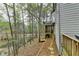 Exterior of home features a tranquil backyard space with trees and creek views at 3230 Riverhill Ct, Cumming, GA 30041