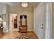 Inviting foyer features hardwood floors and a hall tree with seating at 3230 Riverhill Ct, Cumming, GA 30041