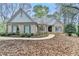 Beautiful single-story home with brick exterior, complementing green shutters, and a meticulously landscaped front yard at 3230 Riverhill Ct, Cumming, GA 30041