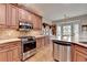 Kitchen with granite countertops, stainless steel appliances, wood cabinets, and a dining nook at 3230 Riverhill Ct, Cumming, GA 30041