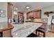 Spacious kitchen featuring an island with granite countertops, wooden cabinets, and stainless steel appliances at 3230 Riverhill Ct, Cumming, GA 30041