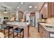 Bright open kitchen featuring an island with granite countertops, wooden cabinets, and stainless steel appliances at 3230 Riverhill Ct, Cumming, GA 30041