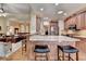 Open kitchen featuring an island with granite countertops, wooden cabinets, and adjacent living area at 3230 Riverhill Ct, Cumming, GA 30041