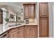 Granite countertop, tiled backsplash, sink, and wooden cabinets are featured in this kitchen at 3230 Riverhill Ct, Cumming, GA 30041