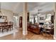 Open-concept living room with hardwood floors, fireplace, and views into the dining room at 3230 Riverhill Ct, Cumming, GA 30041