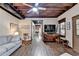 Bright living room featuring wood floors, exposed beam ceiling, and doorway to another room at 3230 Riverhill Ct, Cumming, GA 30041