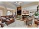 Open floor plan living room with hardwood floors, wood accent wall, and view into kitchen and dining area at 3230 Riverhill Ct, Cumming, GA 30041