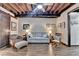 Comfortable living room with wood floors, exposed beam ceiling, and a neutral color palette at 3230 Riverhill Ct, Cumming, GA 30041