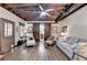 Inviting living room featuring wood floors, exposed beam ceiling, and sliding barn doors at 3230 Riverhill Ct, Cumming, GA 30041
