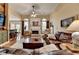 Spacious living room with a fireplace, hardwood floors, and cozy seating area at 3230 Riverhill Ct, Cumming, GA 30041