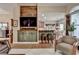 Open floor plan with wood accent wall, comfortable furniture, bar seating and view into the kitchen at 3230 Riverhill Ct, Cumming, GA 30041