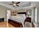 Well-lit main bedroom features hardwood floors, ceiling fan, and neutral walls at 3230 Riverhill Ct, Cumming, GA 30041