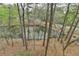 Scenic view of the pond surrounded by mature trees offering a peaceful, natural setting at 3230 Riverhill Ct, Cumming, GA 30041