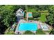 Stunning aerial view of the community pool and recreation area surrounded by mature trees and lush landscaping at 3230 Riverhill Ct, Cumming, GA 30041