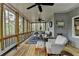 Comfortable screened porch with wood floors, ceiling fans, and relaxing wooded views at 3230 Riverhill Ct, Cumming, GA 30041