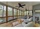 Relaxing screened porch with wood floors, ceiling fans, and wooded views for peaceful enjoyment at 3230 Riverhill Ct, Cumming, GA 30041