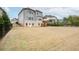 Large backyard view of a two-story home with a fenced yard, deck, and plenty of open green space at 4495 Alister Park Dr, Cumming, GA 30040