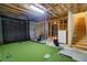 Basement featuring an indoor golf area with putting green, golf equipment, and bright lighting at 4495 Alister Park Dr, Cumming, GA 30040