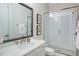 Bathroom with shower, white tile, framed mirror, and vanity with quartz countertop at 4495 Alister Park Dr, Cumming, GA 30040