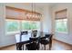 Dining room featuring natural light from large windows and contemporary light fixture above the table at 4495 Alister Park Dr, Cumming, GA 30040