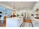Spacious kitchen with stainless steel appliances and a large center island that opens to the living room at 4495 Alister Park Dr, Cumming, GA 30040