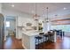 Eat-in kitchen features a center island with seating, modern appliances, and an adjacent dining area with large windows at 4495 Alister Park Dr, Cumming, GA 30040