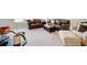 Spacious living room with plush carpeting, leather sofas, comfortable seating, and two large windows at 4495 Alister Park Dr, Cumming, GA 30040