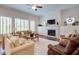 Bright living room with a fireplace, built-ins, and large windows that provide ample natural light at 4495 Alister Park Dr, Cumming, GA 30040