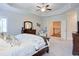 Spacious main bedroom with a tray ceiling, neutral carpeting, and beautiful furnishings at 4495 Alister Park Dr, Cumming, GA 30040