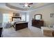 Tranquil main bedroom with trey ceilings, carpeted floors, natural light, and dark wood furniture at 4495 Alister Park Dr, Cumming, GA 30040