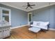 Charming covered patio with a porch swing, grill, and ceiling fan perfect for outdoor relaxation and gatherings at 4495 Alister Park Dr, Cumming, GA 30040