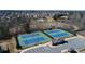 Aerial view of well maintained community tennis courts, pond, and clubhouse at 4495 Alister Park Dr, Cumming, GA 30040