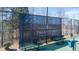Tennis court with community logo screen, benches, and green surface at 4495 Alister Park Dr, Cumming, GA 30040