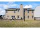 Expansive backyard featuring a well-maintained lawn, a cozy patio with outdoor seating, and mature trees at 543 Walnut Way, Palmetto, GA 30268