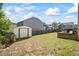 Grassy backyard with shed and perimeter fence at 543 Walnut Way, Palmetto, GA 30268