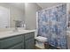 Well-maintained bathroom with a single sink vanity, toilet, and patterned shower curtain at 543 Walnut Way, Palmetto, GA 30268