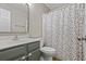 Bright bathroom with a polka dot shower curtain and gray vanity, perfect for a cheerful start to the day at 543 Walnut Way, Palmetto, GA 30268