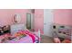 Pink bedroom featuring a paw patrol themed bed with a kitchenette and a doorway to another room at 543 Walnut Way, Palmetto, GA 30268