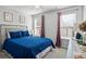 Inviting bedroom with a queen-size bed, neutral walls, and bright windows at 543 Walnut Way, Palmetto, GA 30268