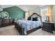 Serene bedroom with a luxurious bed, dark wood furniture, and calming green walls, offering a peaceful retreat at 543 Walnut Way, Palmetto, GA 30268
