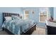 Inviting bedroom with a large bed, bright windows, and soft blue walls, creating a cozy and serene atmosphere at 543 Walnut Way, Palmetto, GA 30268