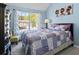 Charming bedroom with blue walls, a patchwork quilt, a large window, and tasteful decor at 543 Walnut Way, Palmetto, GA 30268