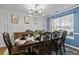 Stylish dining room with modern lighting, seating for eight, and decorative wall accents at 543 Walnut Way, Palmetto, GA 30268
