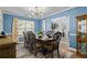 Bright dining room with a large table, modern light fixture, and views into the entryway at 543 Walnut Way, Palmetto, GA 30268