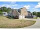A view of the side of the house shows the driveway and two-car garage at 543 Walnut Way, Palmetto, GA 30268