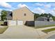 View of the garage with a long concrete driveway and blue sky at 543 Walnut Way, Palmetto, GA 30268