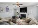 Well-lit living room with a cozy fireplace, TV, comfortable seating, and contemporary decor at 543 Walnut Way, Palmetto, GA 30268