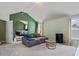 Spacious living area with plush seating, bright windows, and a view into the connected bedroom offering a stylish design at 543 Walnut Way, Palmetto, GA 30268