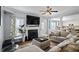 Comfortable living room with fireplace, television, fan and large sectional sofa at 543 Walnut Way, Palmetto, GA 30268