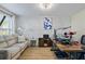 Comfortable office space featuring a sofa, decorative wall paneling, and a work area at 543 Walnut Way, Palmetto, GA 30268